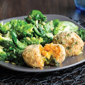 Cheesy risotto balls with warm winter salad