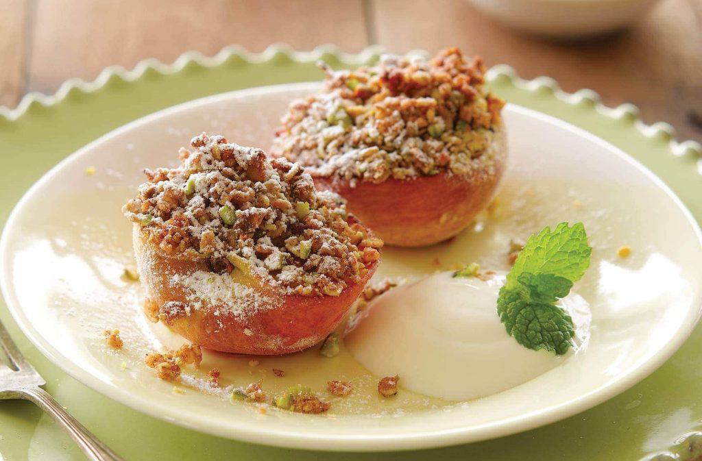 Grilled peaches with berry sauce and pistachio crumble topping Grilled peaches with berry sauce and pistachio crumble topping