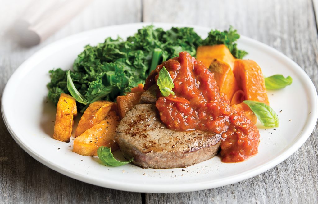 Steak with roasted capsicum, tomato and garlic topping Steak with roasted capsicum, tomato and garlic topping