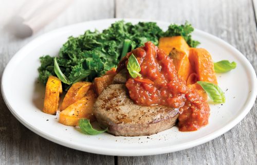 Steak with roasted capsicum, tomato and garlic topping
