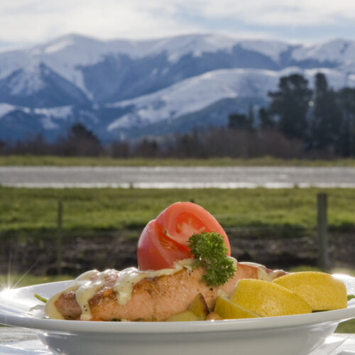food on a plate in front of mountains new zealand