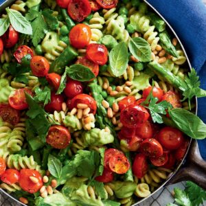 Avocado pesto pasta with peas, asparagus and roasted tomatoes
