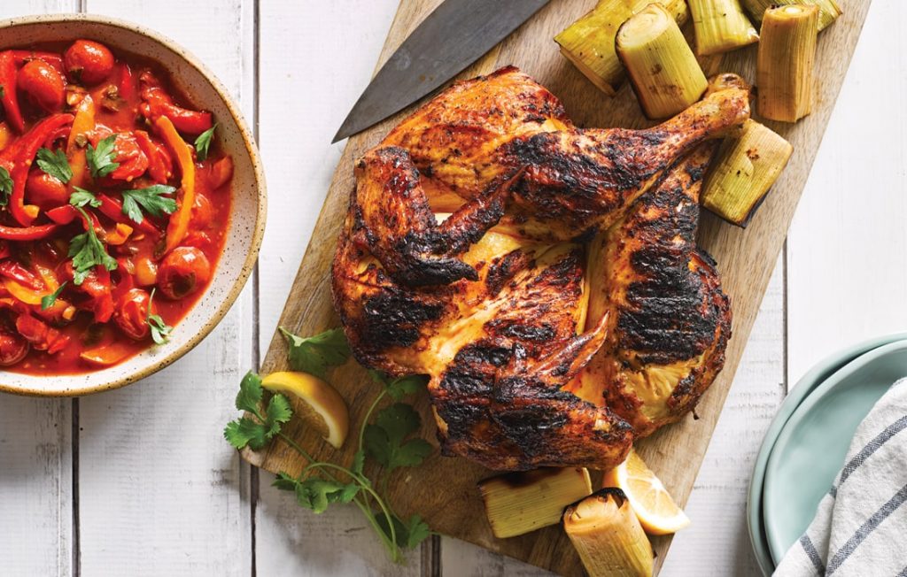 Butterflied harissa chicken with barbecued leek and lemon pepper sauce