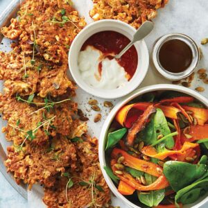 Cauliflower and potato fritters with winter spinach and roasted carrot salad