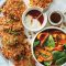 Cauliflower and potato fritters with winter spinach and roasted carrot salad