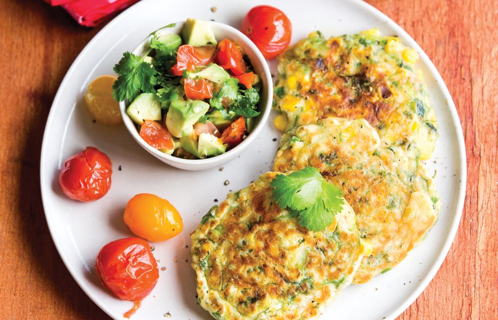Corn fritters with chargrilled cherry tomatoes and avocado salsa Corn fritters with chargrilled cherry tomatoes and avocado salsa