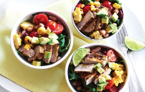 Piri piri pork with grilled corn, avocado and rocket salad