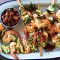 Prawn skewers with lemon, caper and tomato dressing