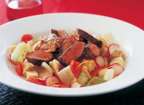 Cucumber, tomato and goats' cheese salad with grilled lamb