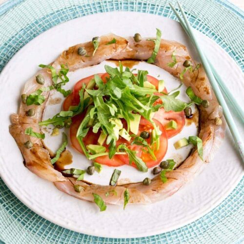 Fish carpaccio with avocado and tomato