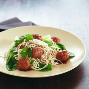 Pork meatballs with egg noodles and Asian greens