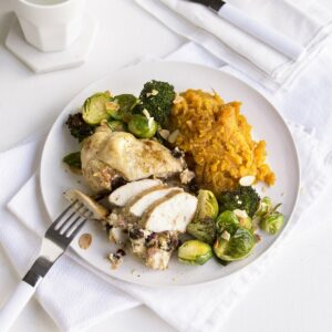 Prune and cream cheese-stuffed chicken breast with roasted greens and toasted almonds