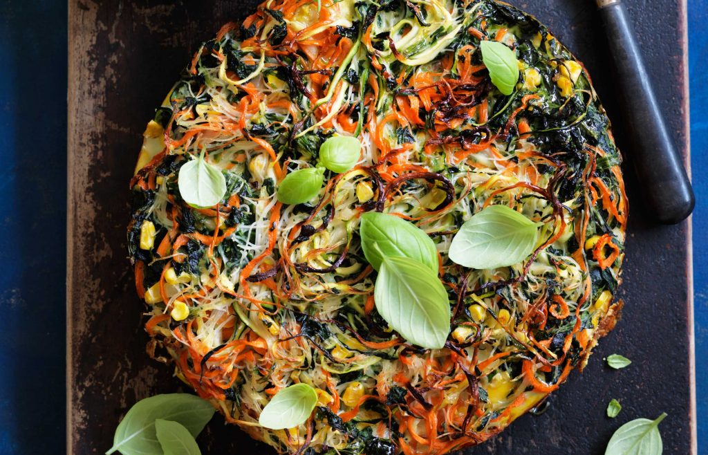 Noodle, vegie and herb frittata fritatta made with vegetables and noodles