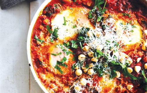 Frying pan baked eggs with harissa and silver beet