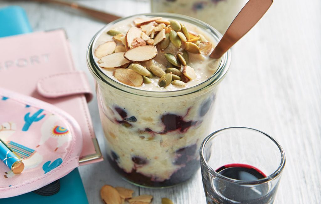Layered berry oats with a cherry juice shot Layered berry oats with a cherry juice shot