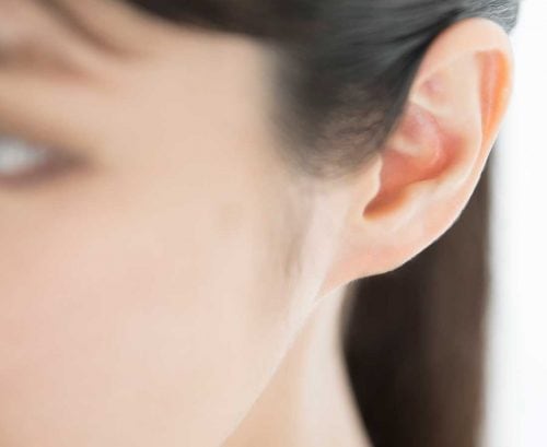 Asian woman's ear - hearing