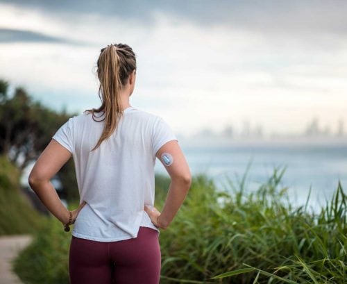 Woman with diabetes looking at view of city across water