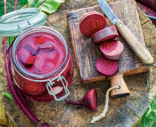 Jar of pickled beetroot and sliced beetroot on a board