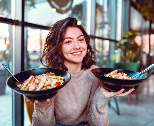 Women holding bowls of food
