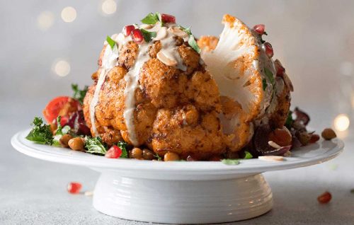 Roasted whole harissa cauliflower, spiced chickpeas and tahini drizzle