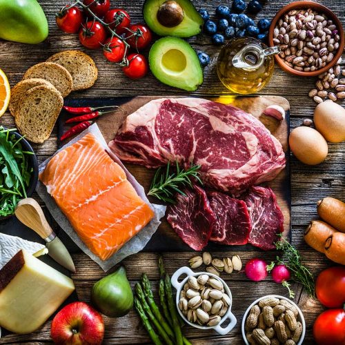 an array of vegetables, fruit, nuts, legumes, fish and meat