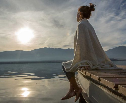 Woman looking into distance over a lake