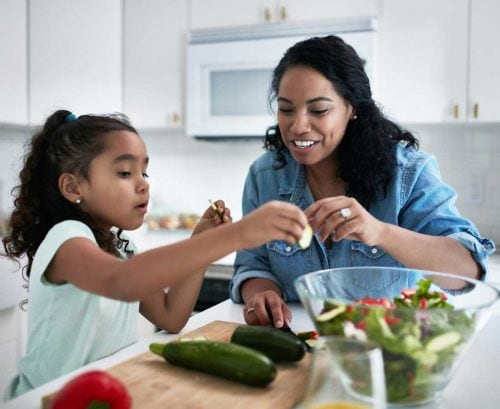 Mother teaching daughter to cook