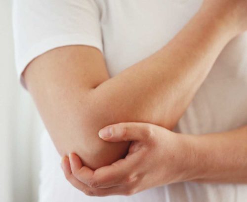 Man holding his elbow
