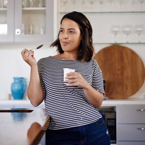 Woman eat probiotc yoghurt for gut health