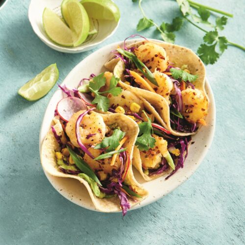 Prawn tacos with charred corn, cabbage and avocado