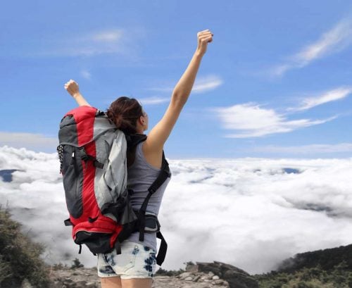 Woman at the top of a mountain