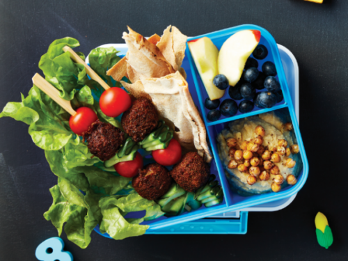 Falafel kebabs with pita chips, hummus and fruit