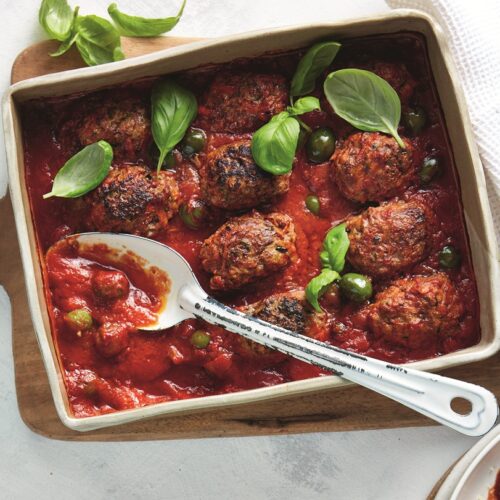 Baked lamb meatballs with tomatoes, olives and couscous