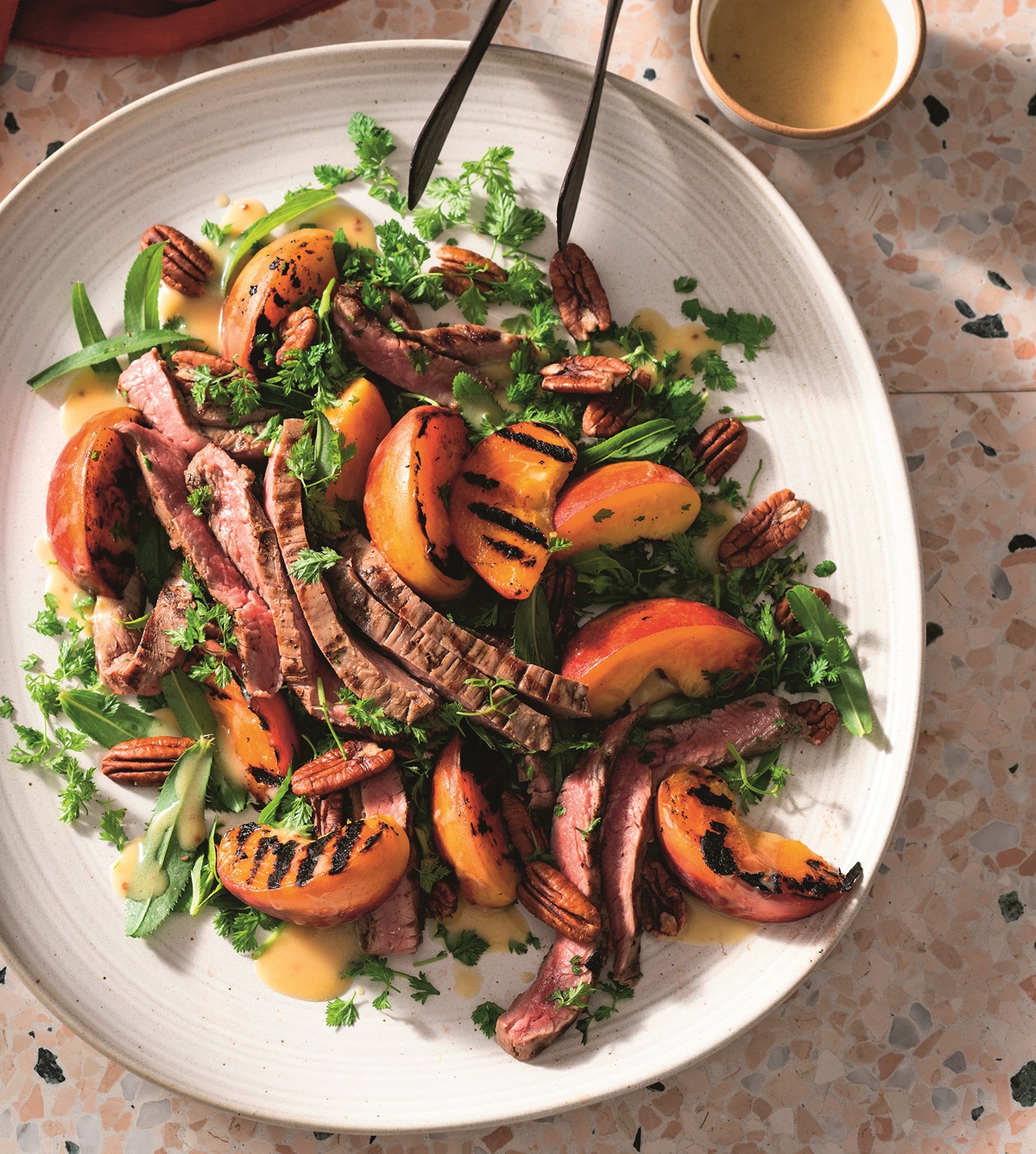 Flank steak salad with pecans and charred peaches